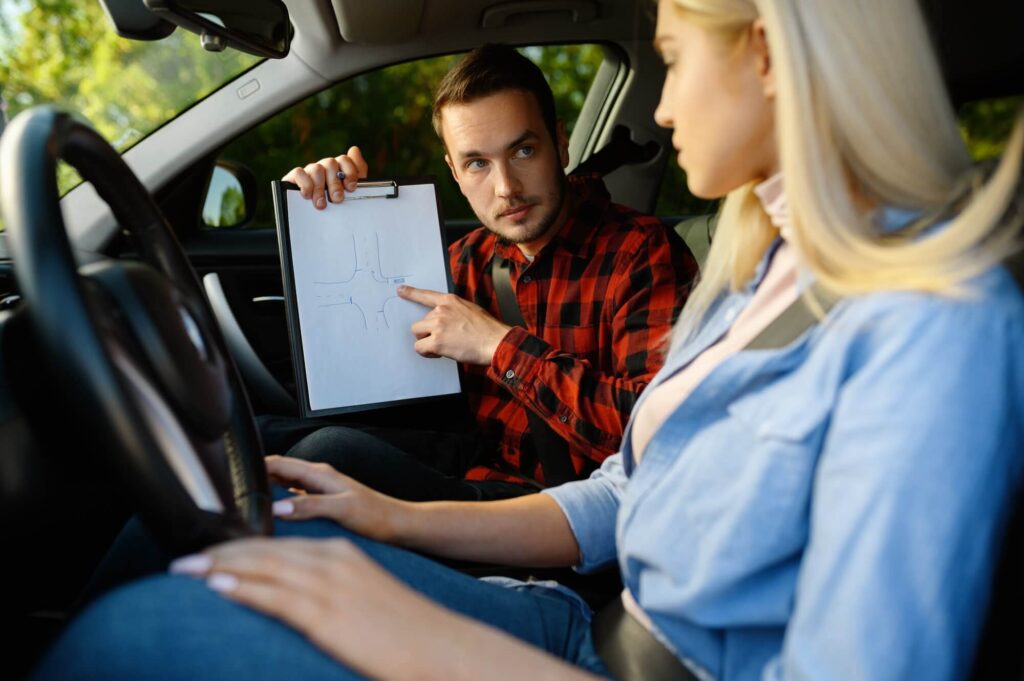 woman and man with checklist driving school 1